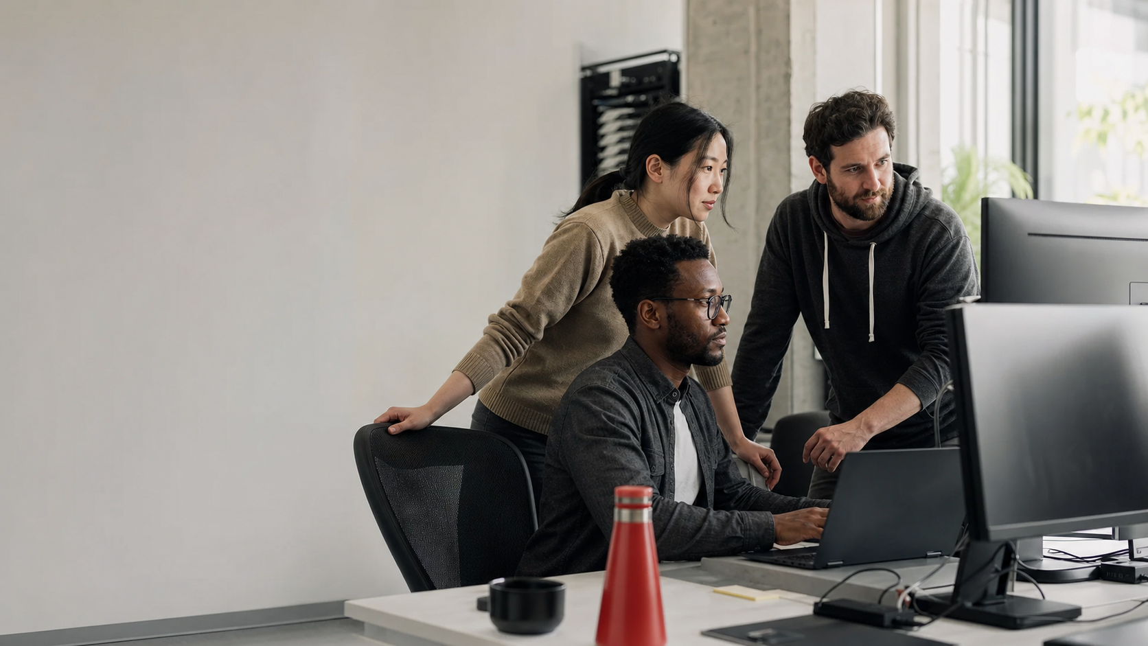 Software developers collaborating in a modern engineering workspace